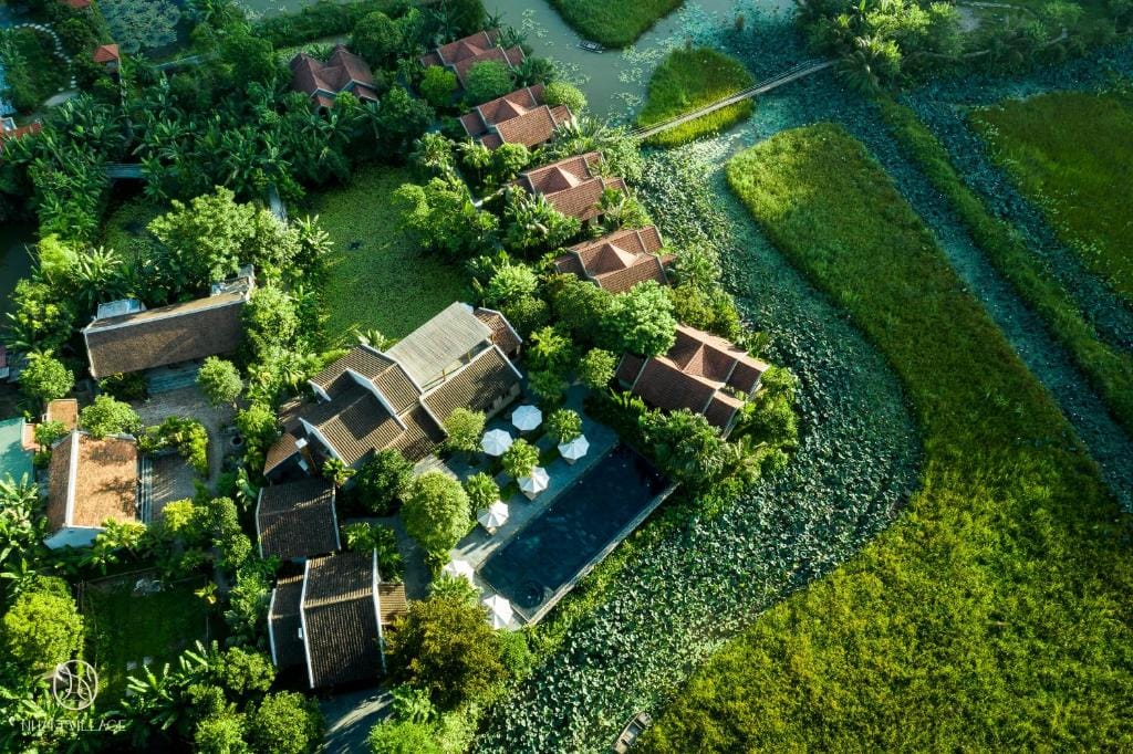 An aerial view of Nham Village Resort, offering space, stillness, and serenity framed by farmland and limestone peaks