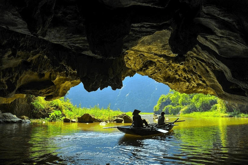 A boat trip on the Ngo Dong River is the signature experience in Tam Coc