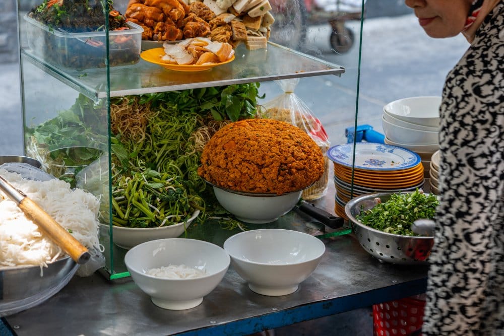 savoring local dishes in a rustic eatery, a must-try in any Ninh Binh Cuisine Guide.