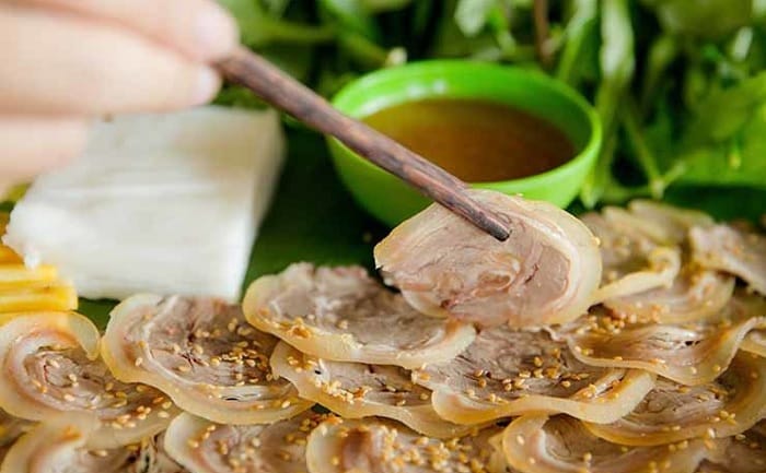 Savory rare-cooked goat with lime and ginger, a must-try favorite for international foodies.