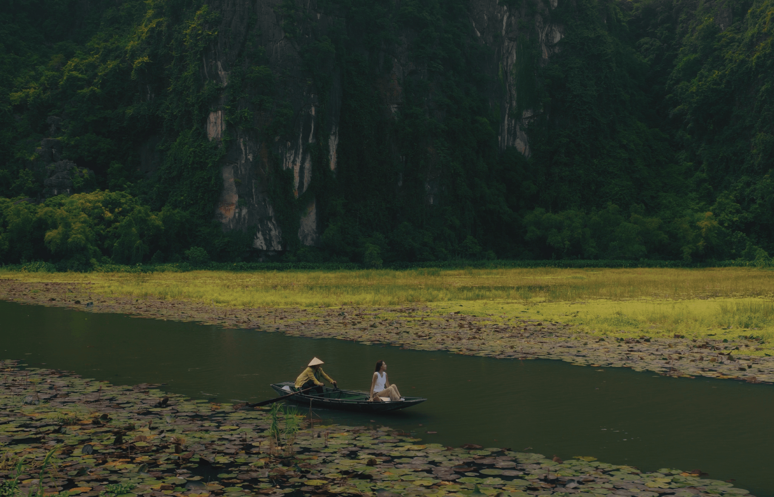 Discerning global voyagers exploring the symmetry and ancient architectural lines of a traditional wellness estate.  