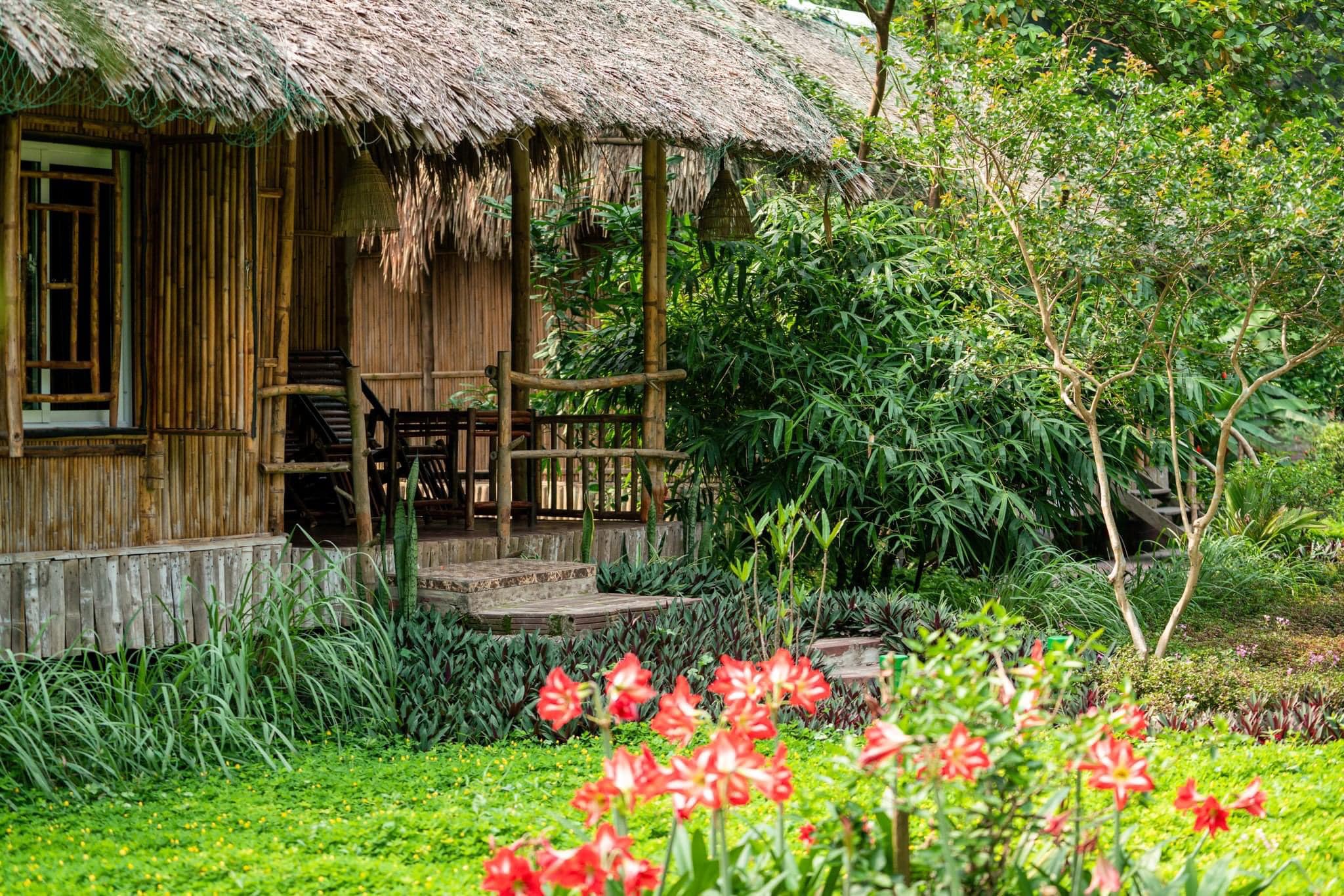 Lake-view bungalows and mountain scenery at An’s Eco Garden, a nature-focused and rustic-chic Trang An Resort.