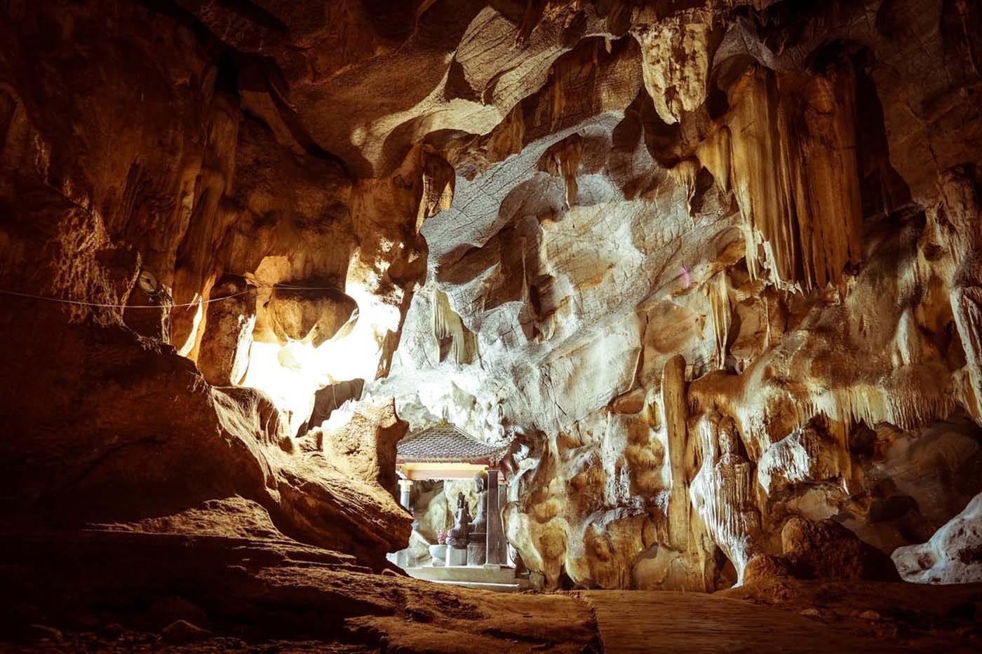 A visitor walking through the spacious, cool interior chambers, shaped over millions of years.