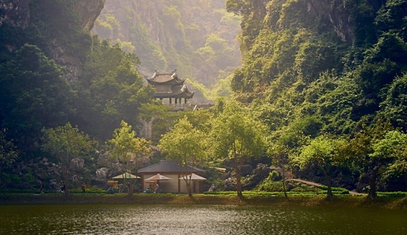 Sustainable Travel Vietnam: A Guide to More Responsible Journeys Clear morning sunlight illuminating an untouched mountain valley free from tourist crowds.