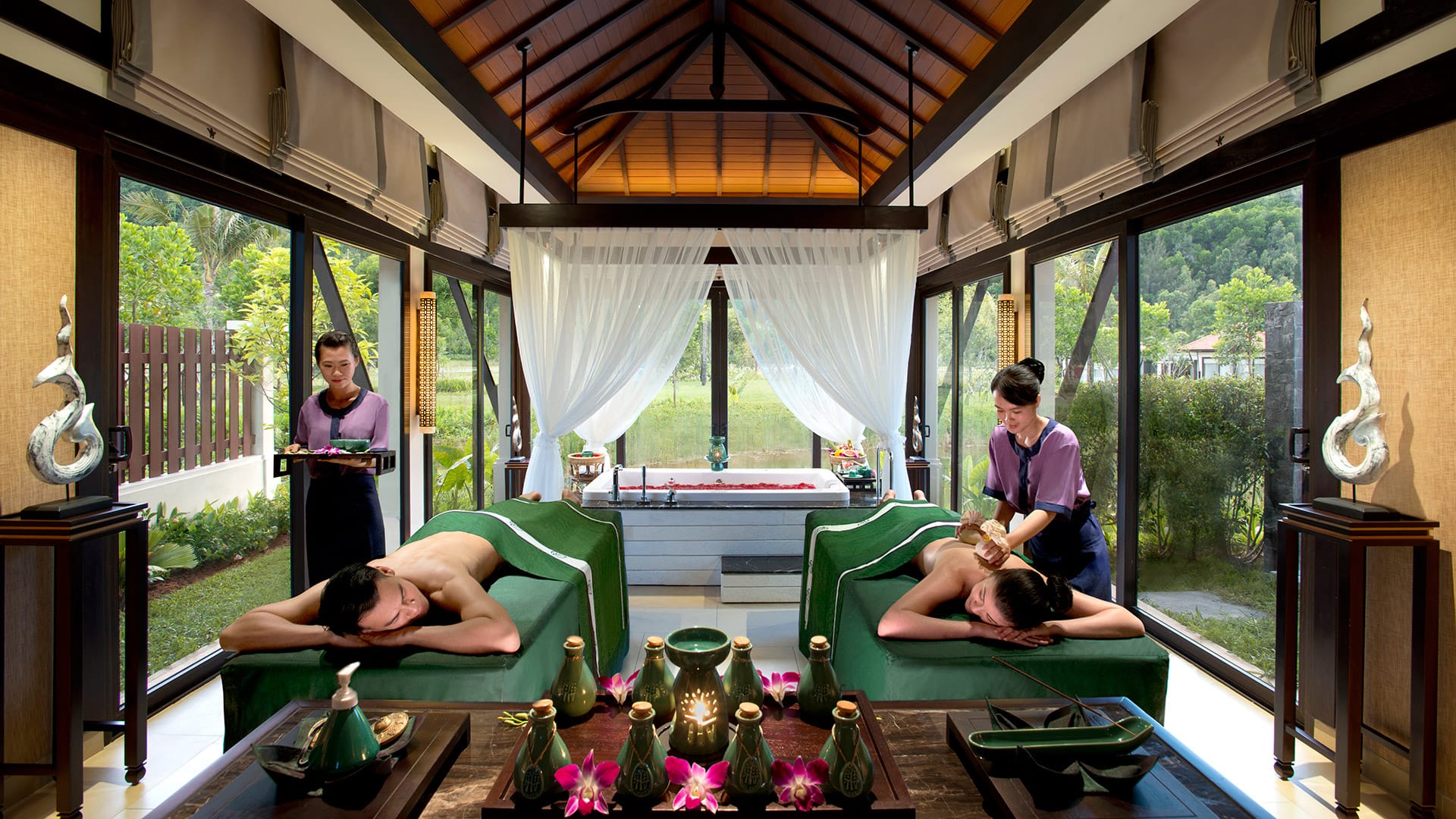 A serene treatment room opening up to lush mountain views and gentle ocean breezes.  