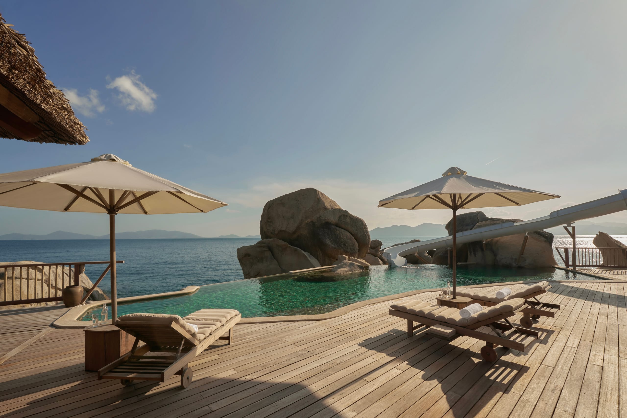 The perfect architectural harmony where luxury eco-villas rest smoothly between dramatic mountain ridges and the ocean waves.  
